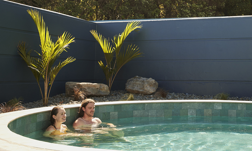 people relaxing and soaking in the Mount Hot Pools in Mount Maunganui